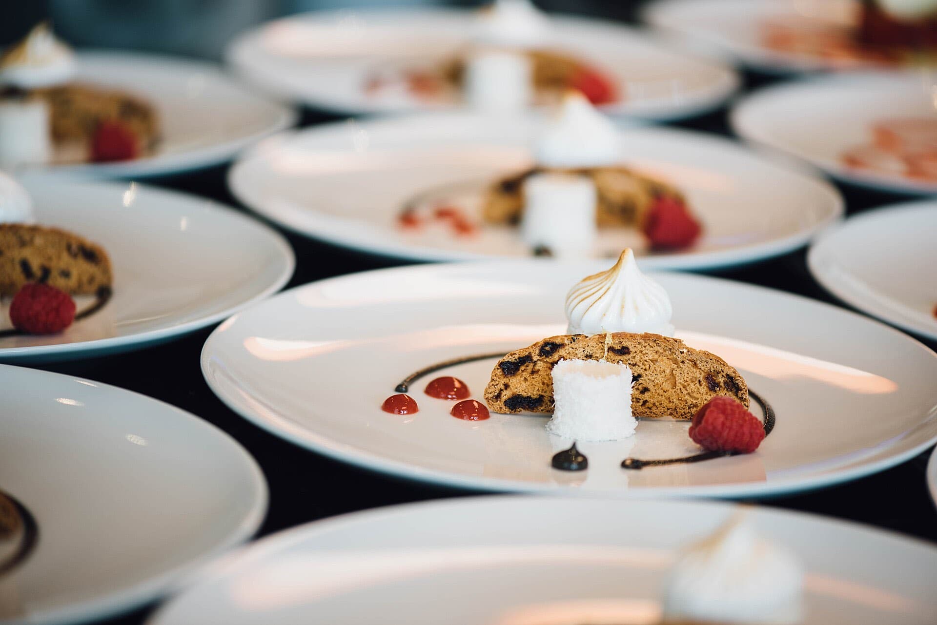Rows of plated desserts being prepared for service
