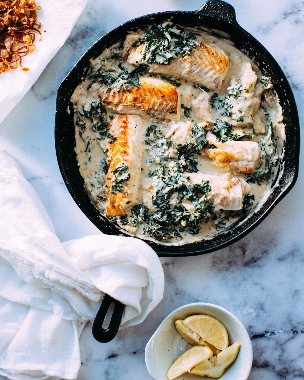 Fish baked with greens in a cast-iron skillet, from above