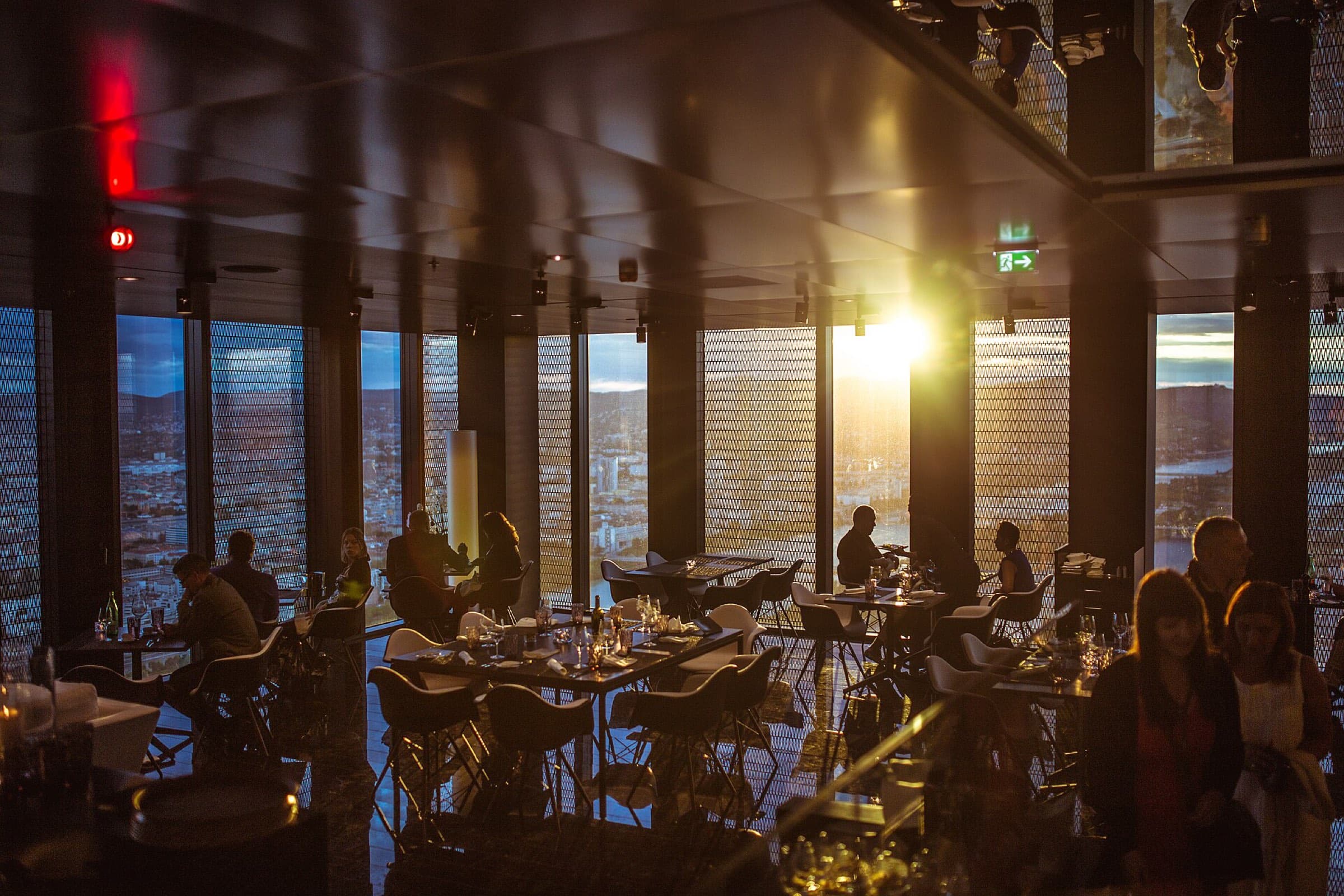 A dining room at dusk, with warm light falling across the tables